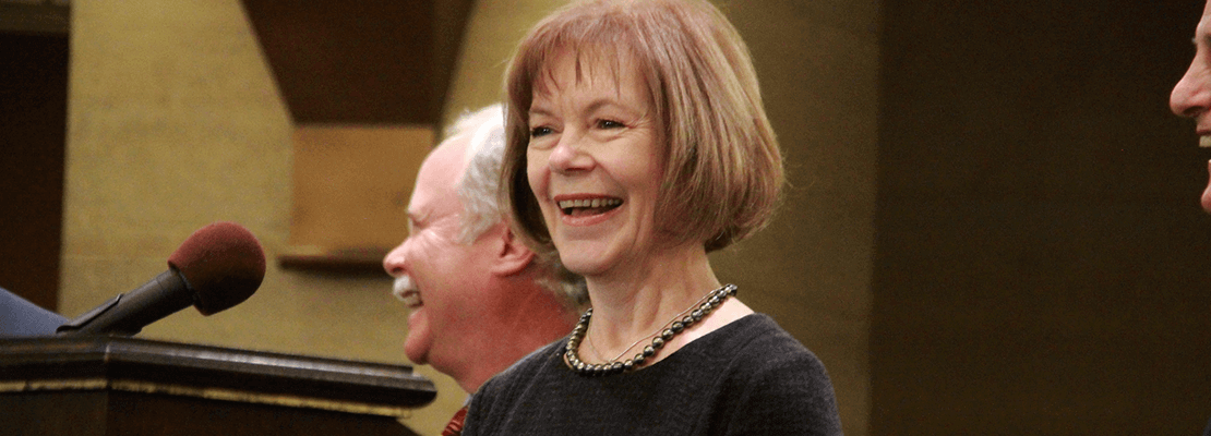 Senator Tina Smith at a podium