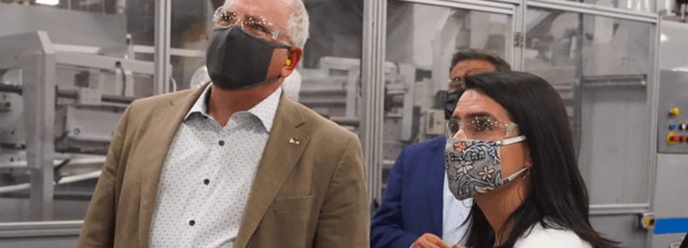 Governor Walz and Lt. Governor Flanagan wear masks as they tour a factory