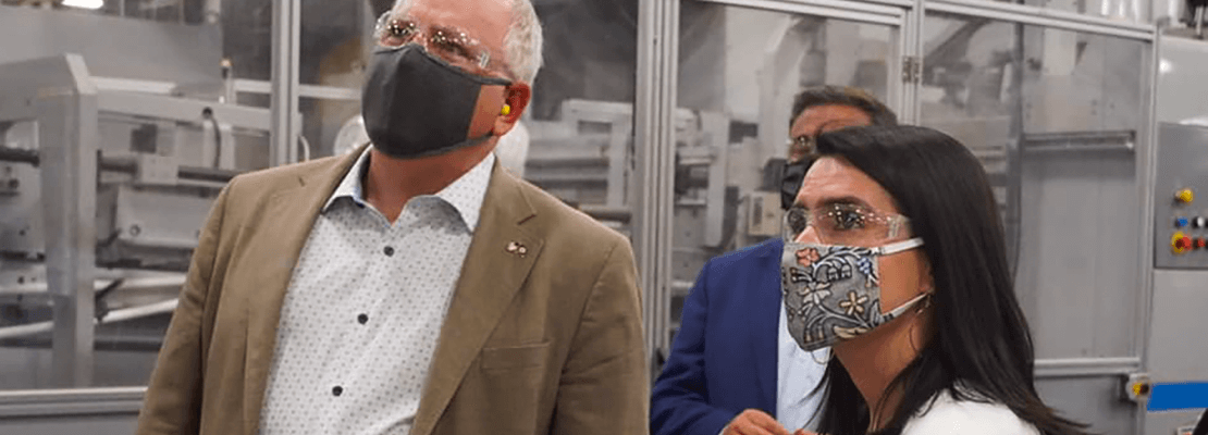 Governor Walz and Lt. Governor Flanagan wear masks as they tour a factory