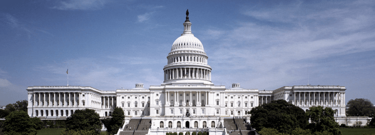 The U.S. Capitol building in front of a blue sky