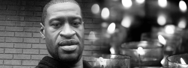 black and white image of George Floyd and lit candles on a dark background