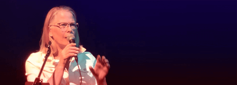 Image of Kim Crockett with a microphone