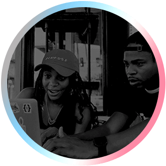 Image of two people looking at a laptop computer